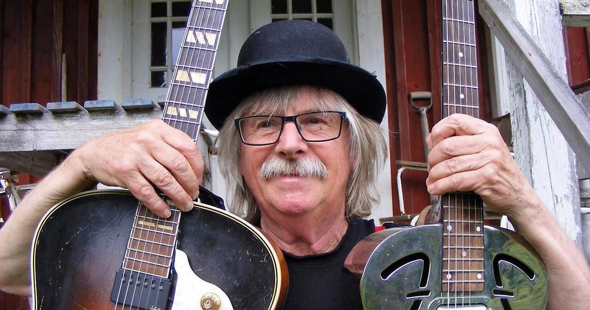 Bild på Cornelis van Son alias Catfish Charly med en gitarr i varje hand.