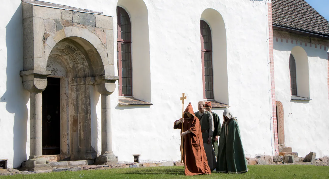 En grupp människor som står framför en kyrka.